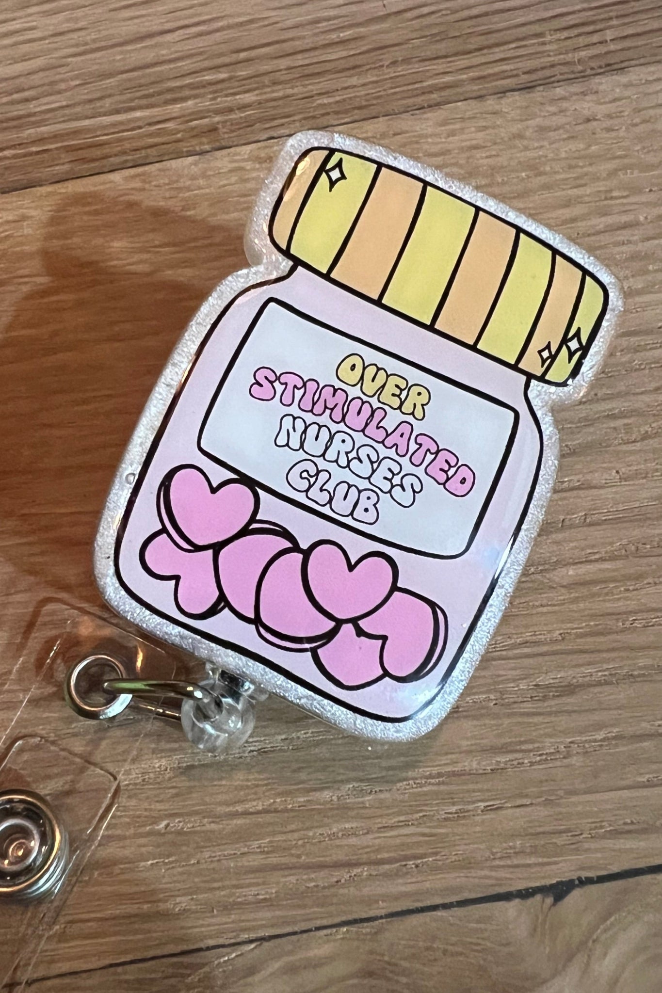 Overstimulated Nurses Club – Sarcastic Heart Pill Jar Badge Reel with Free Badge Bling!