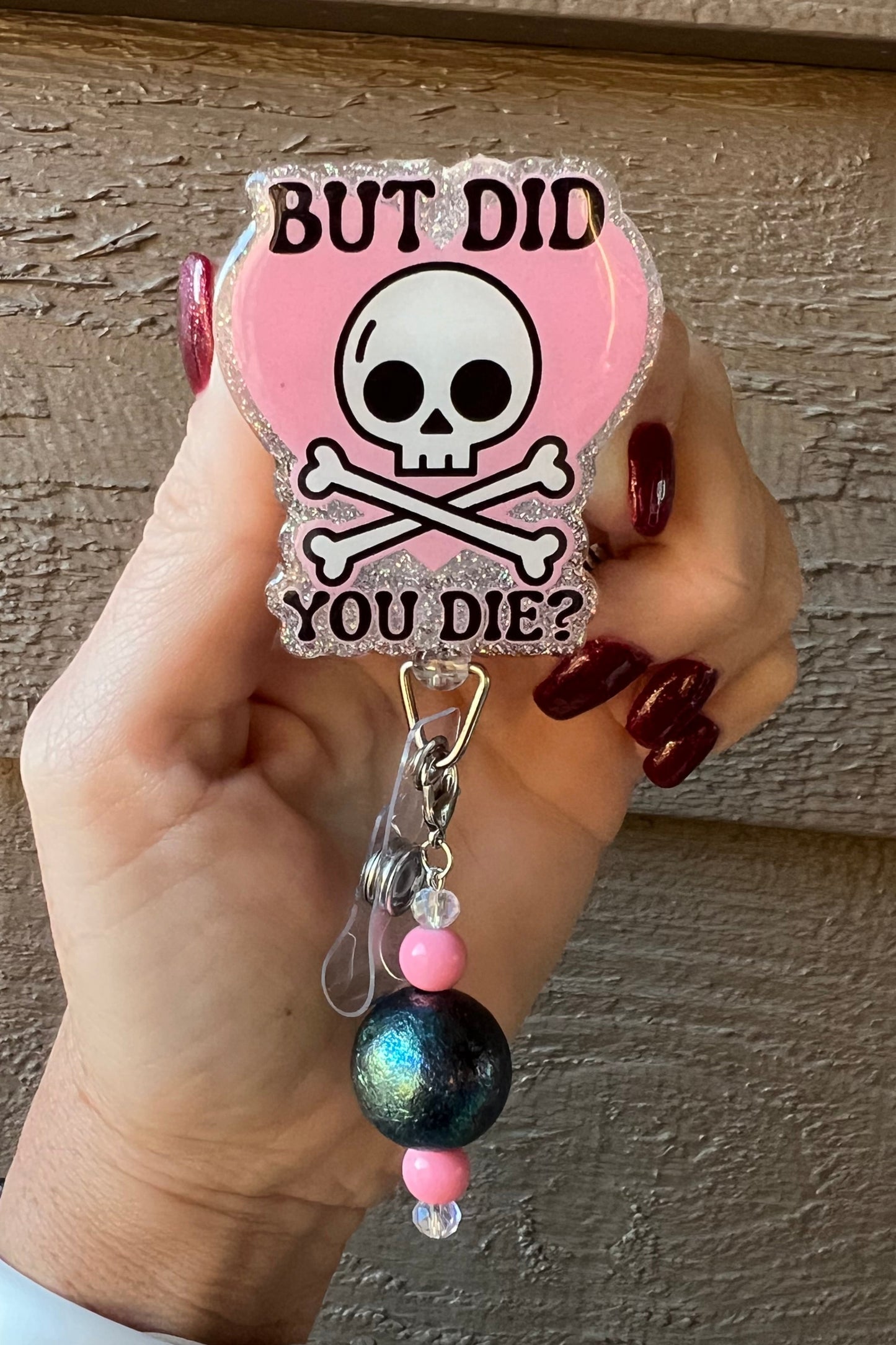 Badge Reel with Skull and Crossbones over a heart with text "But Did you Die?" with holographic silver border and coordinating badge bling.