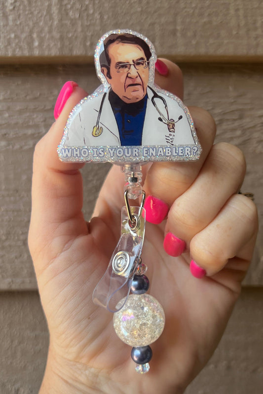 Badge Reel with "Who is your enabler?' text and illustrated Dr. Nowzarden from "My 600 pound Life", featuring a glittery border and navy/crystal beaded dangle.