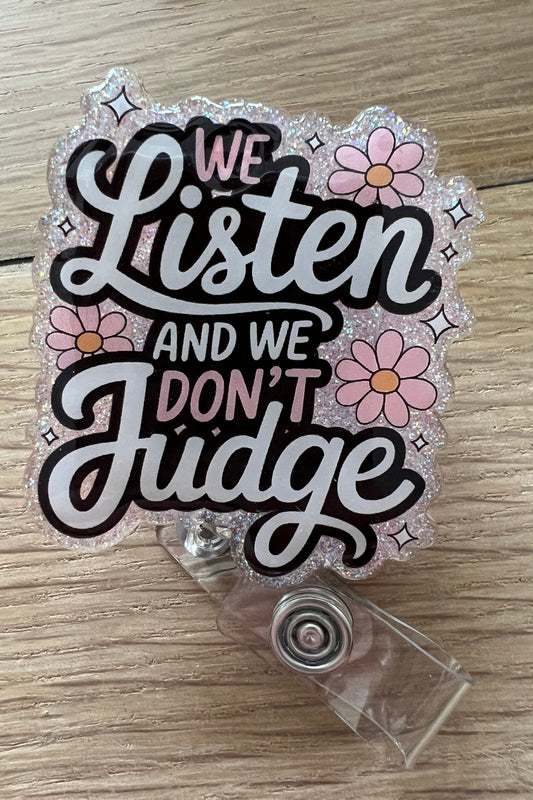 Pink Glitter Badge reel that says "We Listen and we don't judge" with flowers around the words
