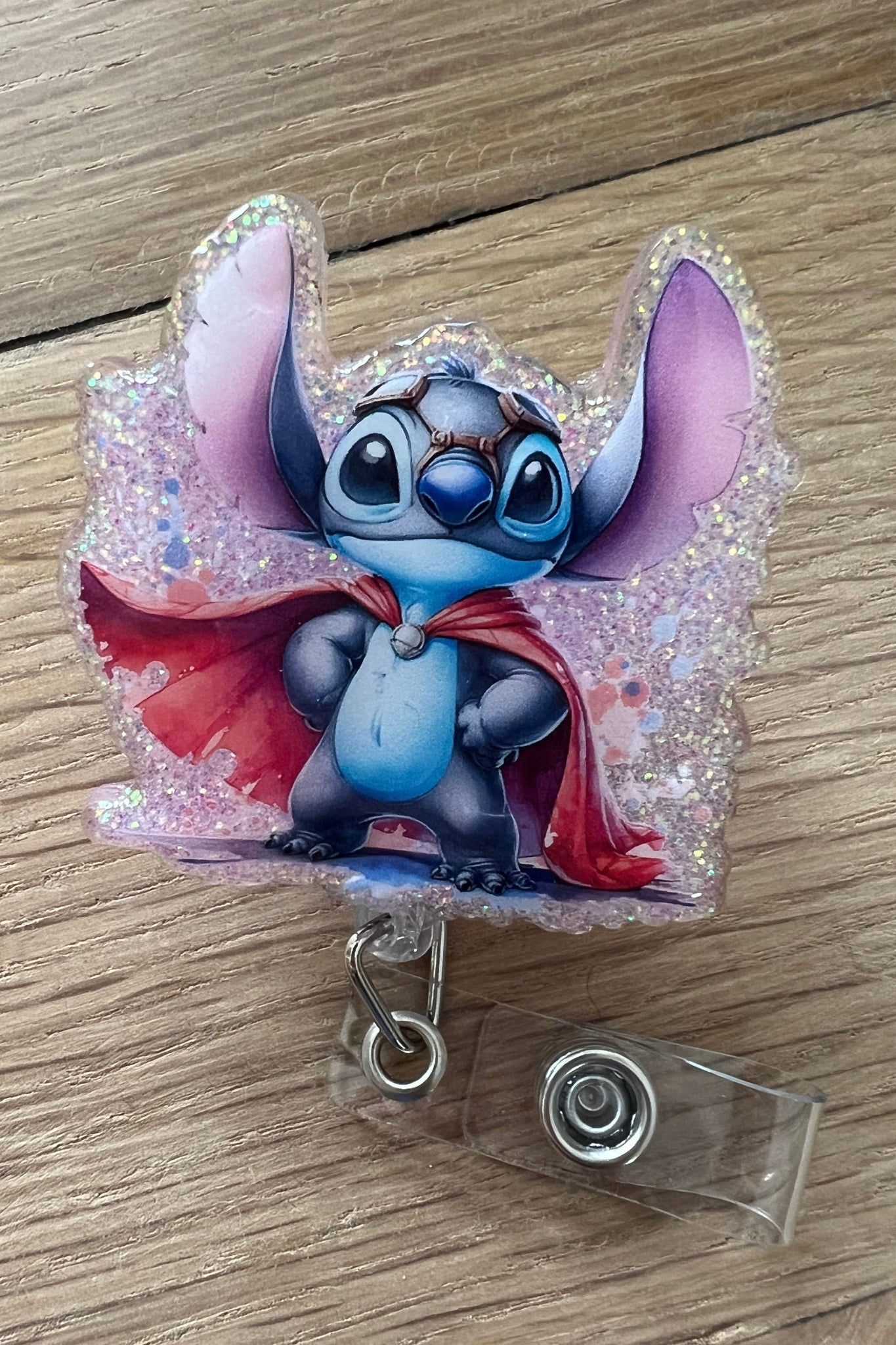 Superhero Stitch Badge Reel on soft purple glitter background