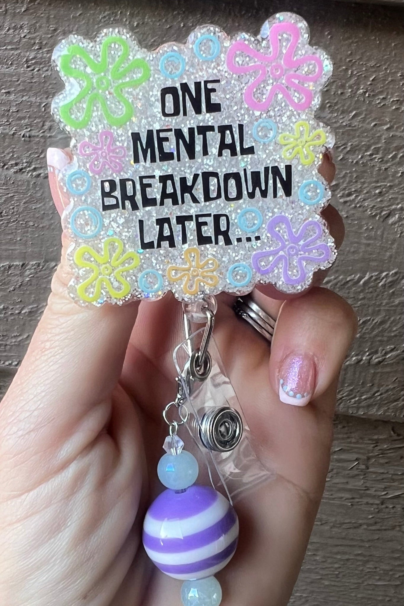 One Mental Breakdown Later text and bikini bottom style font with white sparkle glitter background.