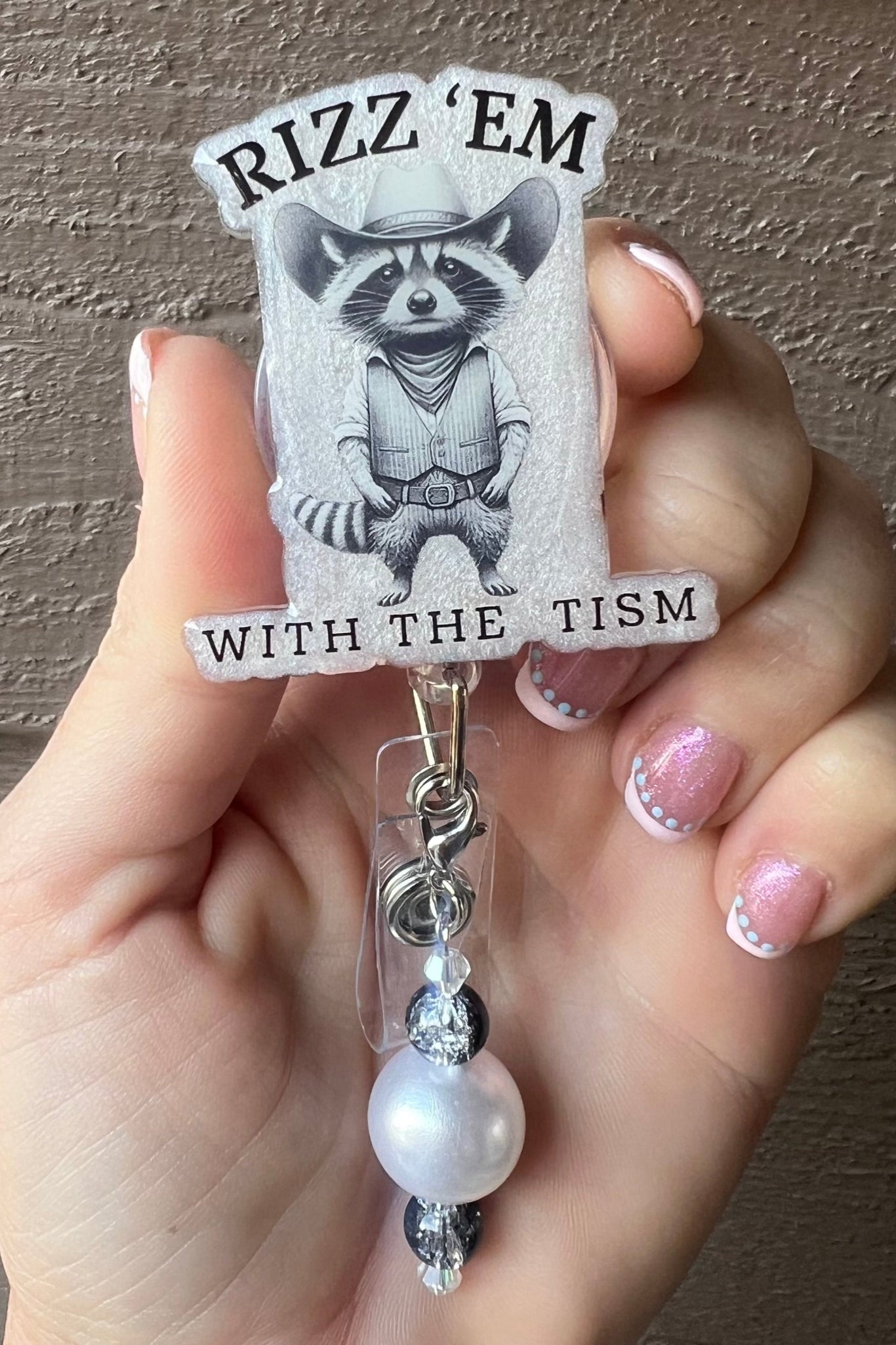 Rizz ’Em With the Tism Badge Reel – Funny Cowboy Raccoon ID Holder with Free Badge Bling!