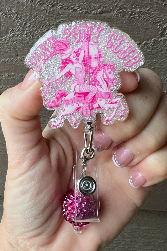 A soft glittery badge reel inspired by Chappell Roan's Pink Pony Club, showing a retro pink cowgirl on a carousel pony with coordinating badge bling.
