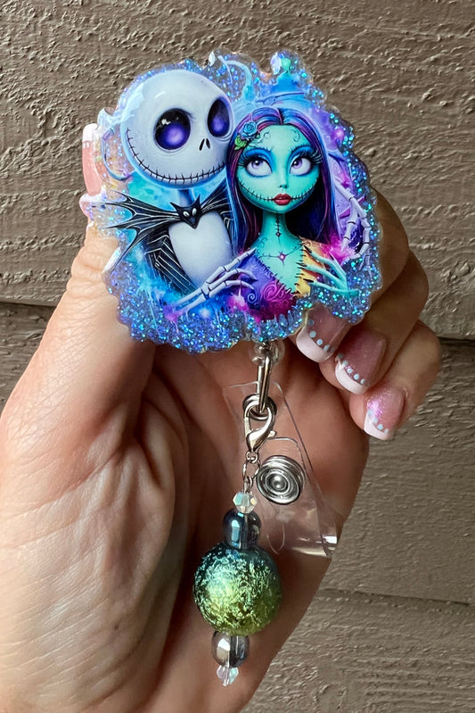 Jack and Sally characters from The Nightmare Before Christmas Badge Reel bordered by blue glitter with coordinating badge bling.