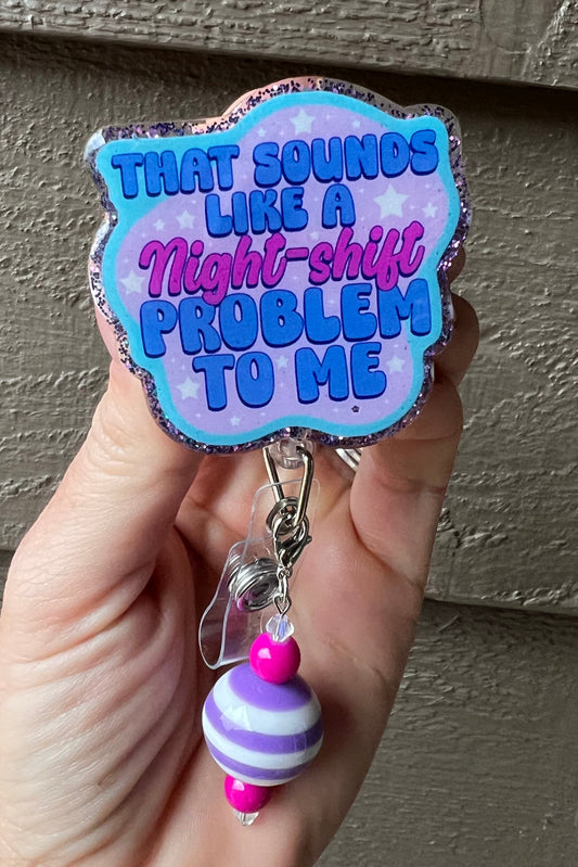 A glittery badge reel with the phrase "That sounds like a night-shift problem to me" paired with a coordinating badge bling.