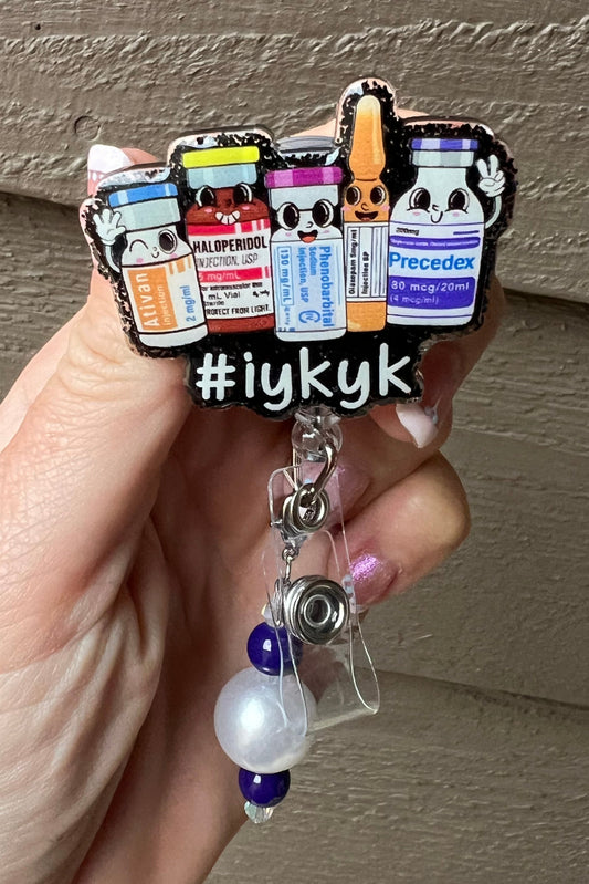 Cartoon medication badge reel with the text #IYKYK and coordinating badge bling.