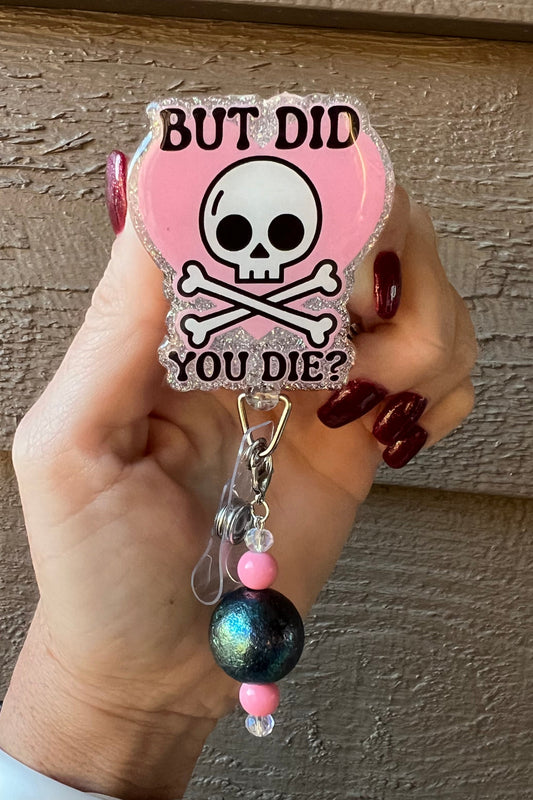 Badge Reel with Skull and Crossbones over a heart with text "But Did you Die?" with holographic silver border and coordinating badge bling.