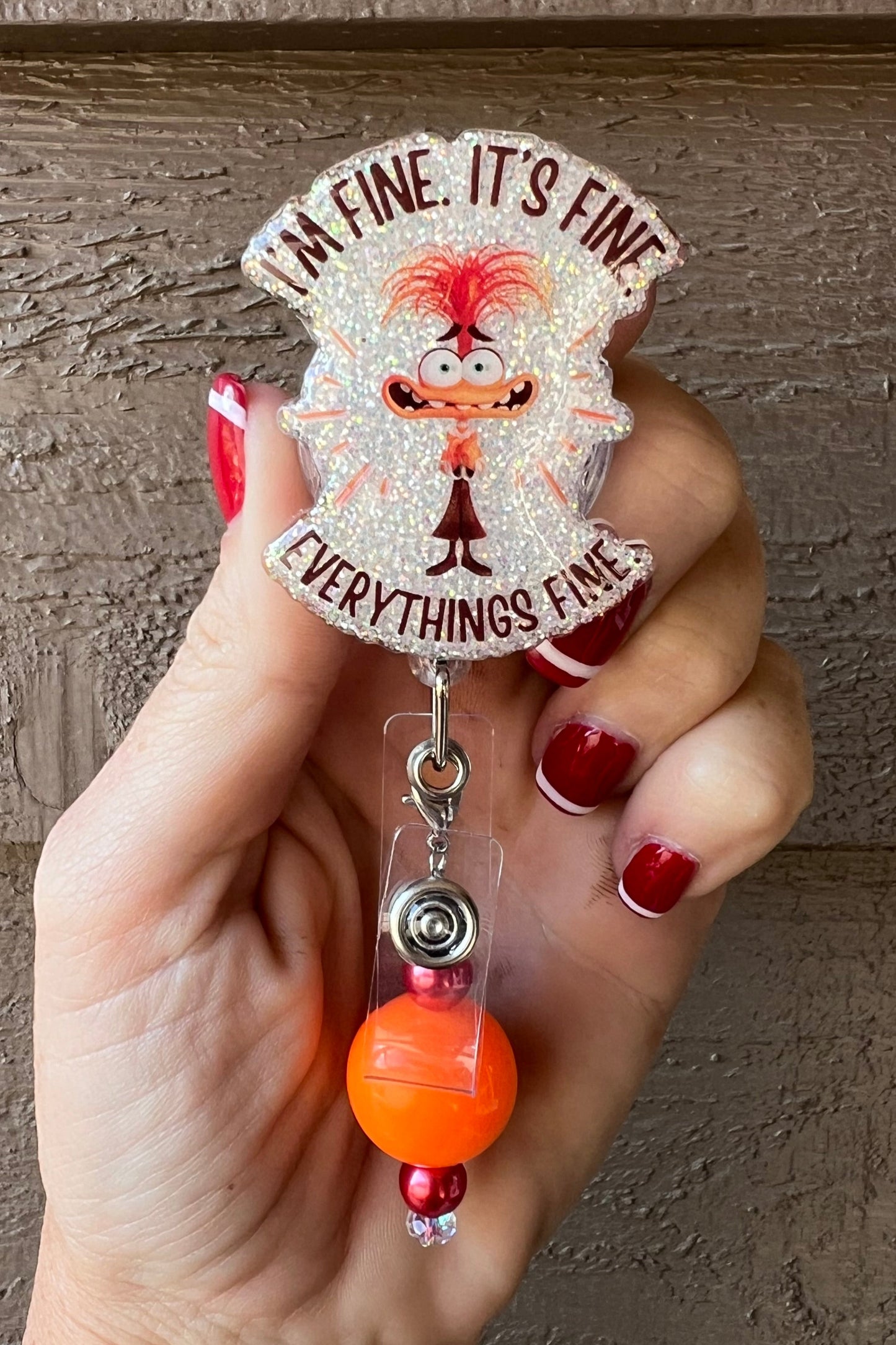 Anxiety from Inside out 2 with the phrase "I'm fine. It's find. EVERYTHING'S FINE." over soft pearl glitter and orange beaded dangle.