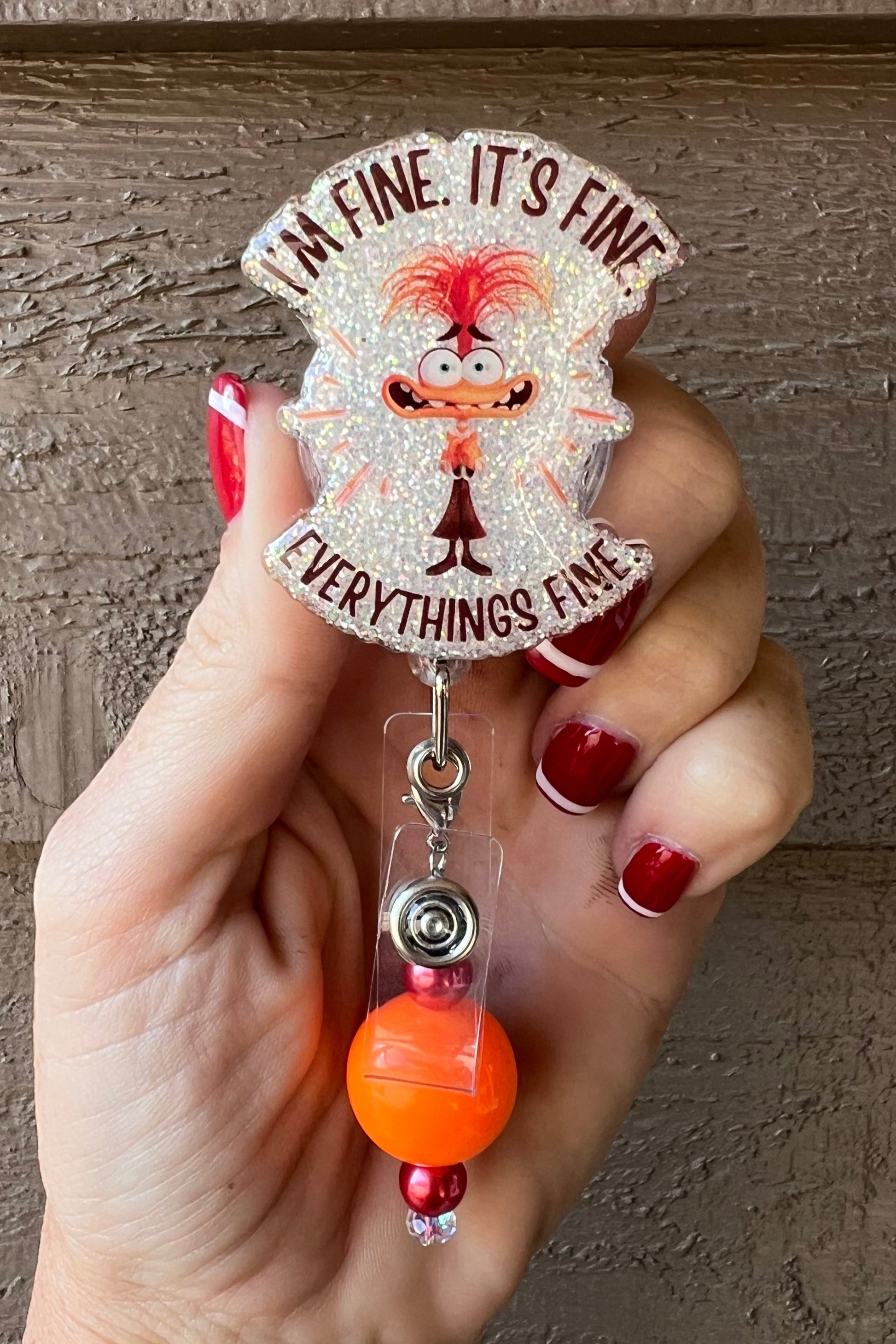 Anxiety from Inside out 2 with the phrase "I'm fine. It's find. EVERYTHING'S FINE." over soft pearl glitter and orange beaded dangle.